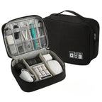 Black travel organizer with electronic devices inside on a white background