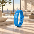 A bright blue silicone wristband watch with a digital LED display showing the time 20:48, standing upright on a marble tabletop in a modern, sunlit living room.