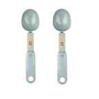 Two digital measuring spoons with gray handles and bowls on a white background