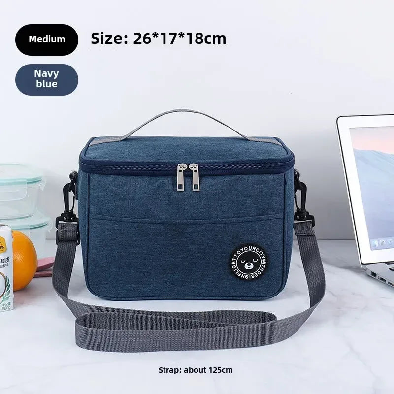 Navy blue cooler bag with strap on a white surface, size and strap length information displayed.