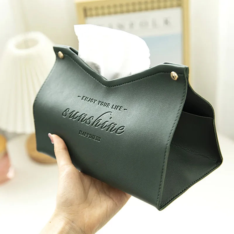 Green tissue holder with 'Enjoy your life, sunshine, happiness' text held by a hand.