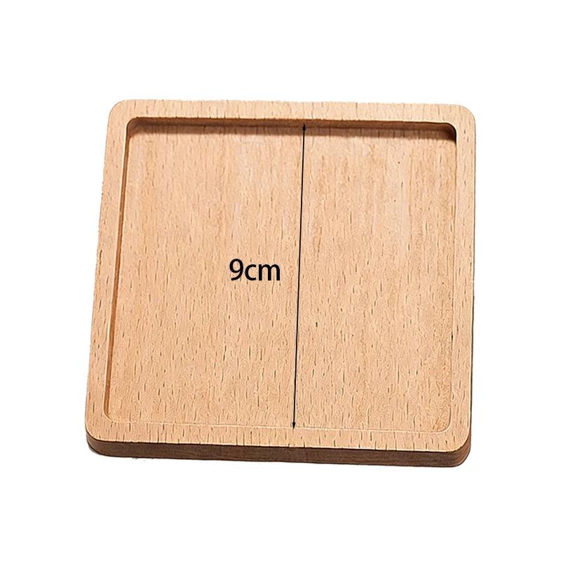 Wooden square block with measurement '9cm' on a white background