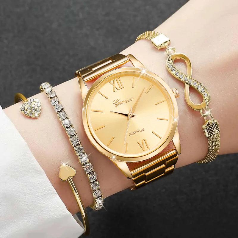 Gold watch and bracelets on a wrist against a dark background