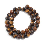 A double-strand beaded stretch bracelet made of polished tiger's eye beads, arranged in a circular shape on a clean white background.