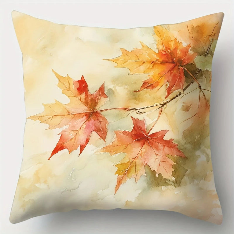 Decorative pillow with autumn leaf design on a light background