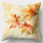 Decorative pillow with autumn leaf design on a light background