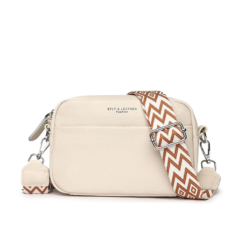 Beige handbag with a patterned strap on a white background