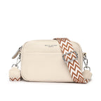 Beige handbag with a patterned strap on a white background