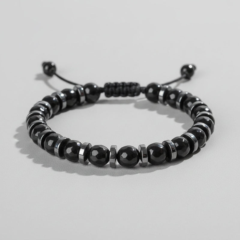 Black beaded bracelet on a wooden surface with 'Self-Love' text