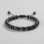 Black beaded bracelet on a wooden surface with 'Self-Love' text