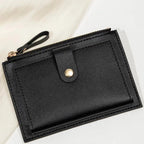 Black wallet with a zipper on a light background