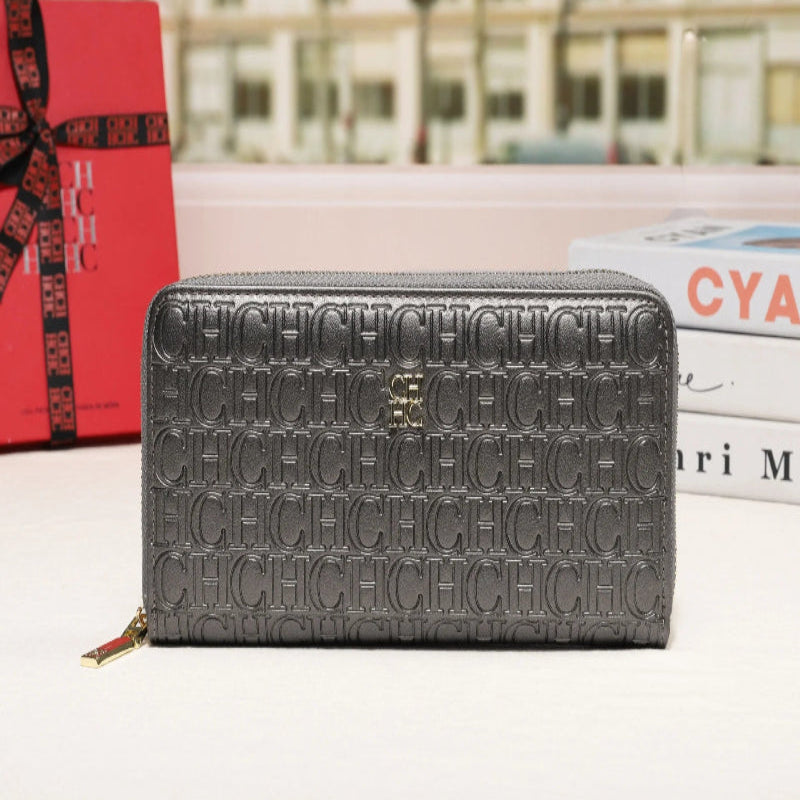 Gray wallet with 'CHIC' text pattern on a surface with a blurred cityscape background