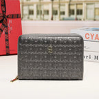 Gray wallet with 'CHIC' text pattern on a surface with a blurred cityscape background