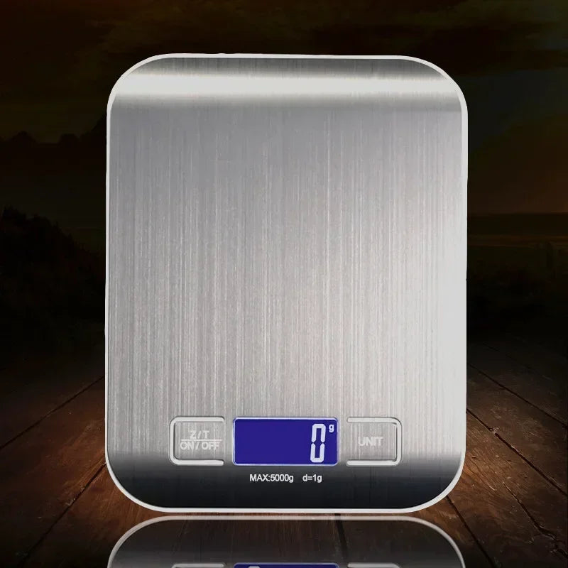 Silver digital kitchen scale on a wooden surface with a dark background