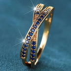 Gold ring with blue gemstones on a blue background