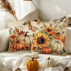 Decorative pillow with autumn-themed design featuring pumpkins and sunflowers on a couch.