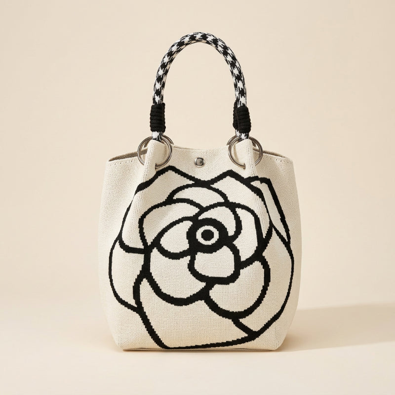 Woman holding a floral tote bag on a beach