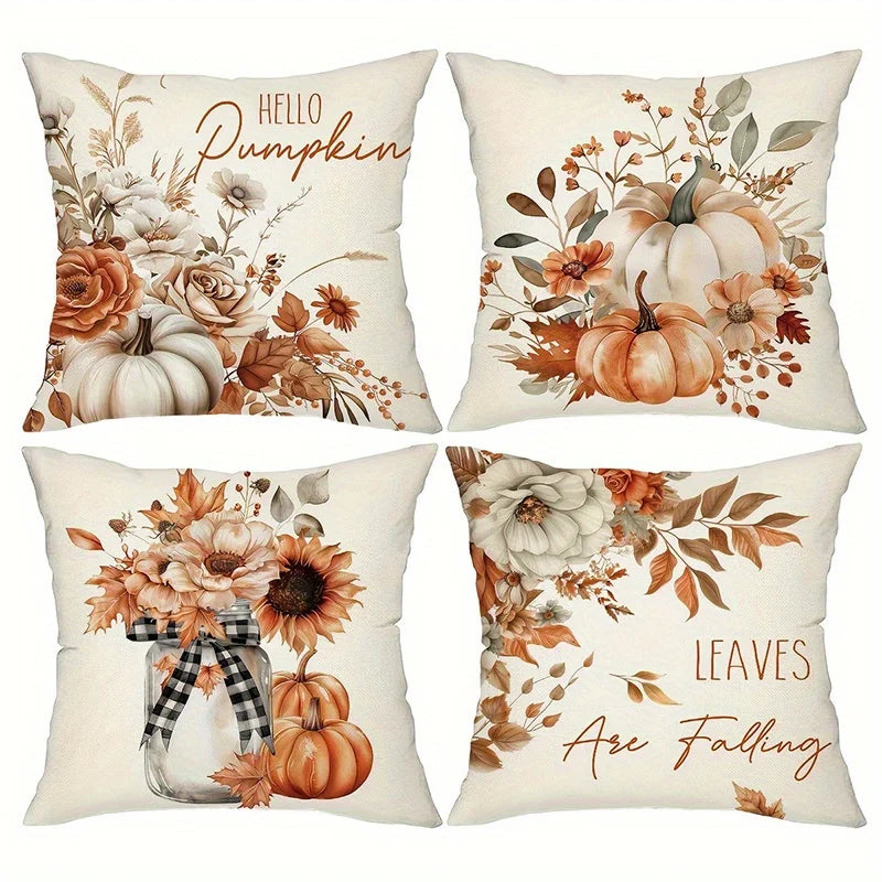 Four square throw pillows arranged in a 2x2 grid, each with a different autumn floral design on an off-white background. The designs include pumpkins, flowers, leaves, and phrases like 'HELLO Pumpkin' and 'LEAVES Are Falling' in warm fall colors.