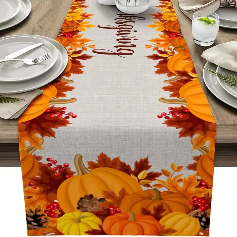 Thanksgiving-themed table runner with pumpkins and leaves on a wooden table.