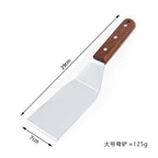 Measuring tool showing a spatula with a wooden handle and metal blade, labeled with dimensions and weight.