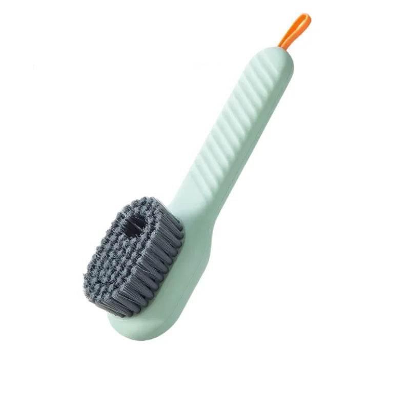 Light green scrub brush with a gray bristle head on a white background