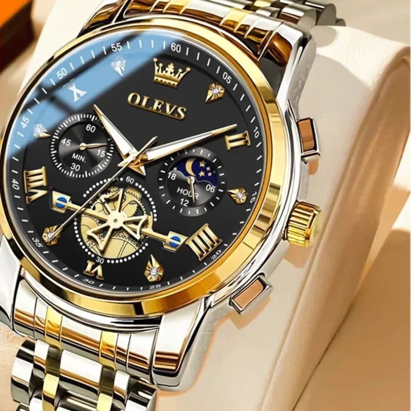 Gold and silver watch with black face on a beige background, featuring the OLEVS brand.