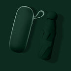 A dark green compact umbrella shown next to its matching hard-shell carrying case on a dark green background.