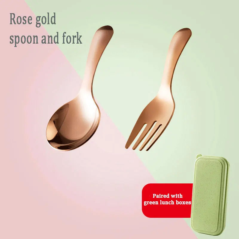 Rose gold spoon and fork set with a green lunch box on a pink and green gradient background.