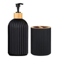 Black ribbed soap dispenser and holder with wooden pump and lid on a white background