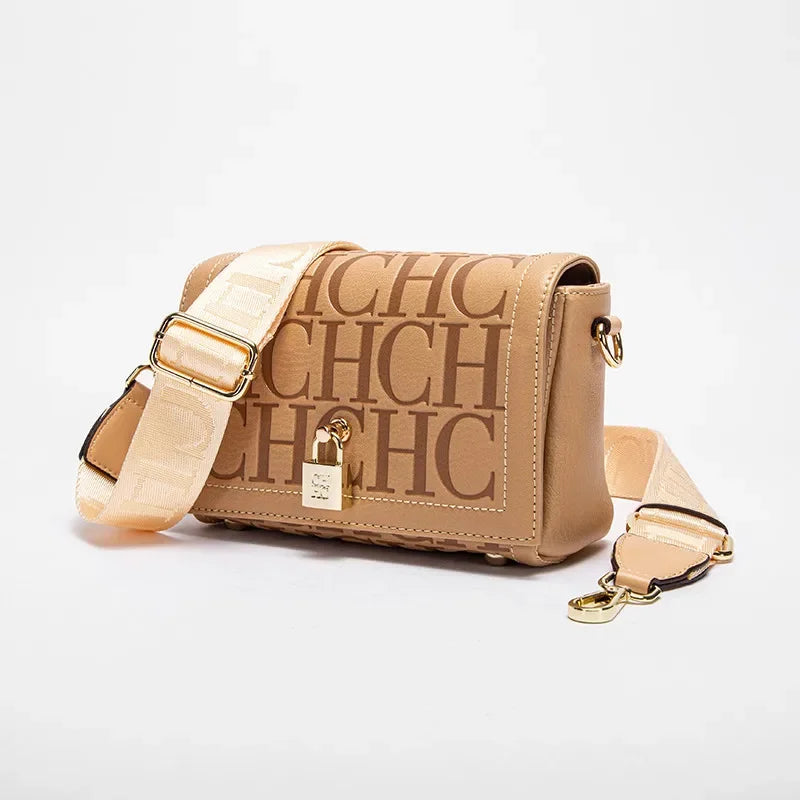 Beige handbag with gold accents on a light gray background