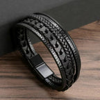 Black braided leather bracelet on a wooden surface