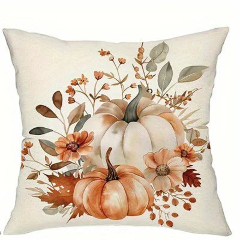 A square decorative throw pillow with a warm autumn floral print featuring pumpkins, leaves, and flowers on an off-white background.