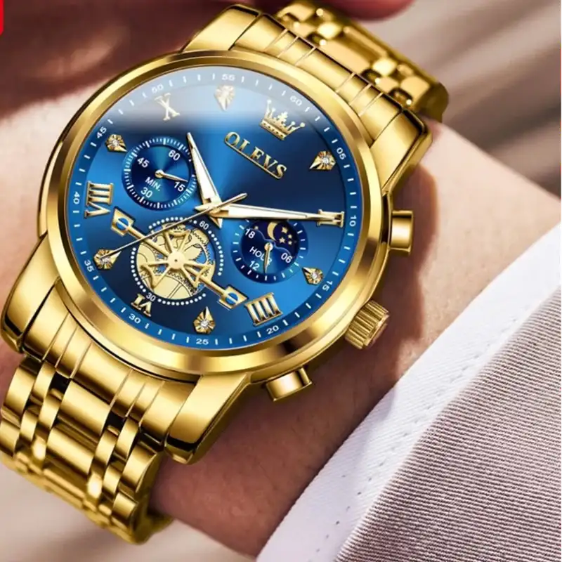 Gold wristwatch with blue face on a wrist, brand 'OLEVS' visible