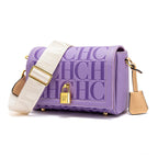 Purple handbag with white strap and gold accents on a white background