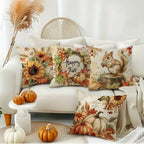 Decorative pillows with autumn-themed designs on a white sofa.