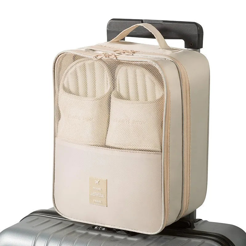 Beige travel packing cube with mesh compartments on a suitcase