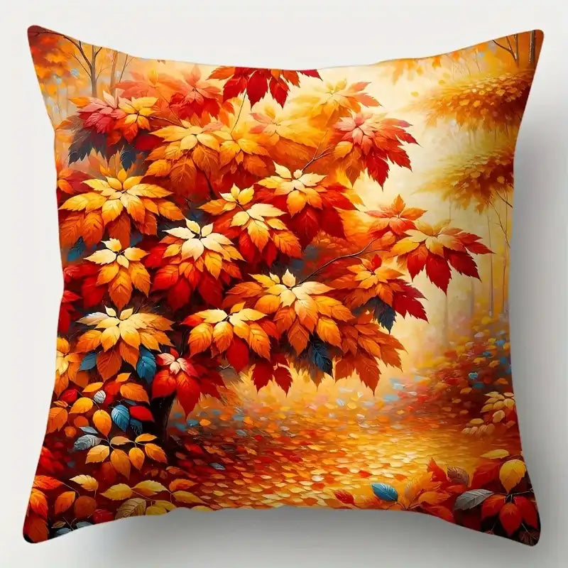 Decorative pillow with autumn leaf design on a white background
