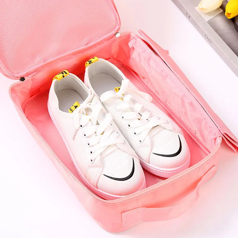 White sneakers with black accents in a pink shoe organizer
