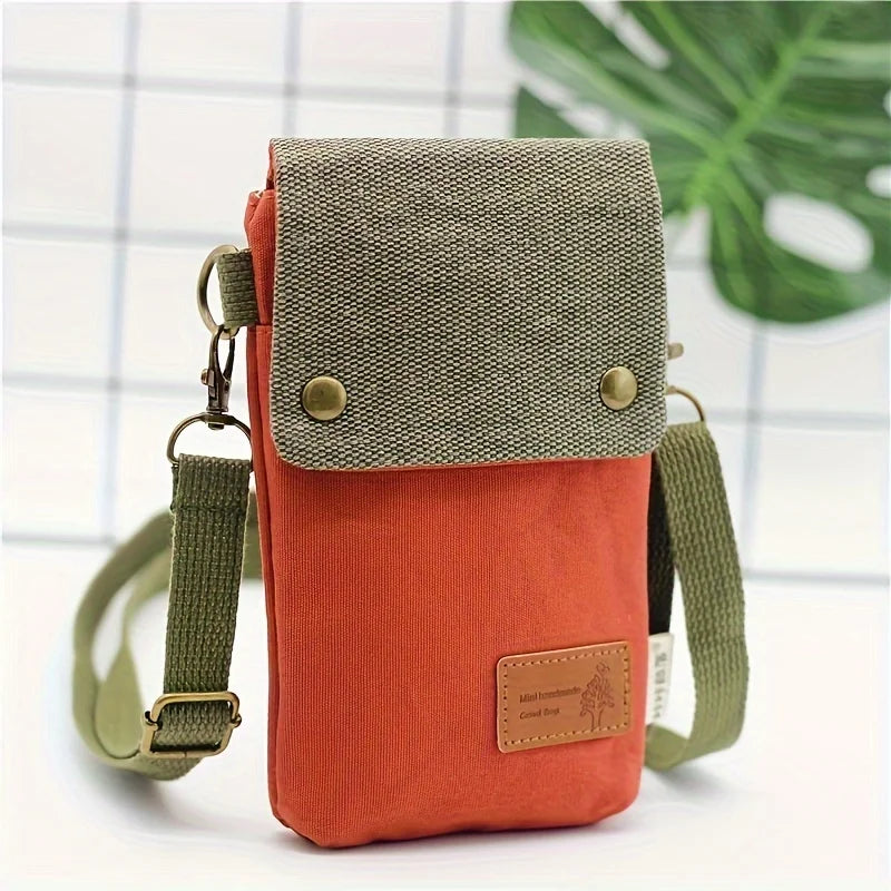 Orange and green crossbody bag with a visible brand label on a white background