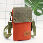 Orange and green crossbody bag with a visible brand label on a white background