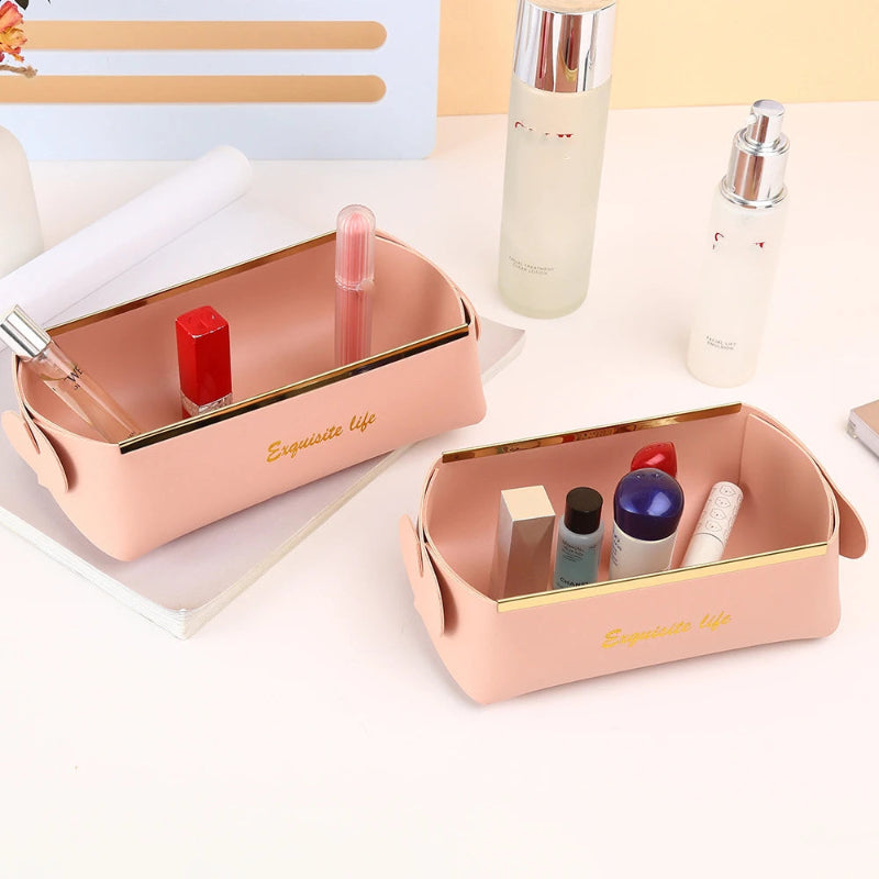 Pink cosmetic bags with various items on a light surface