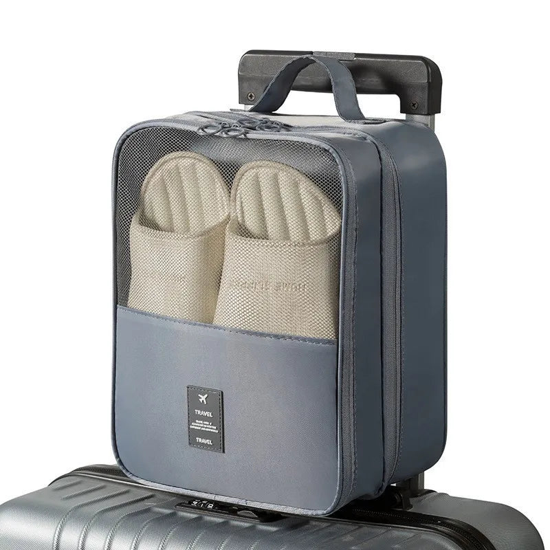 Gray shoe organizer with beige slippers on a white background
