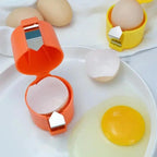 Egg shell peeler with cracked eggs on a white surface