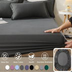 Gray bedding set on a bed with '100% Cotton Vave' branding, showing a hand adjusting the fitted sheet.