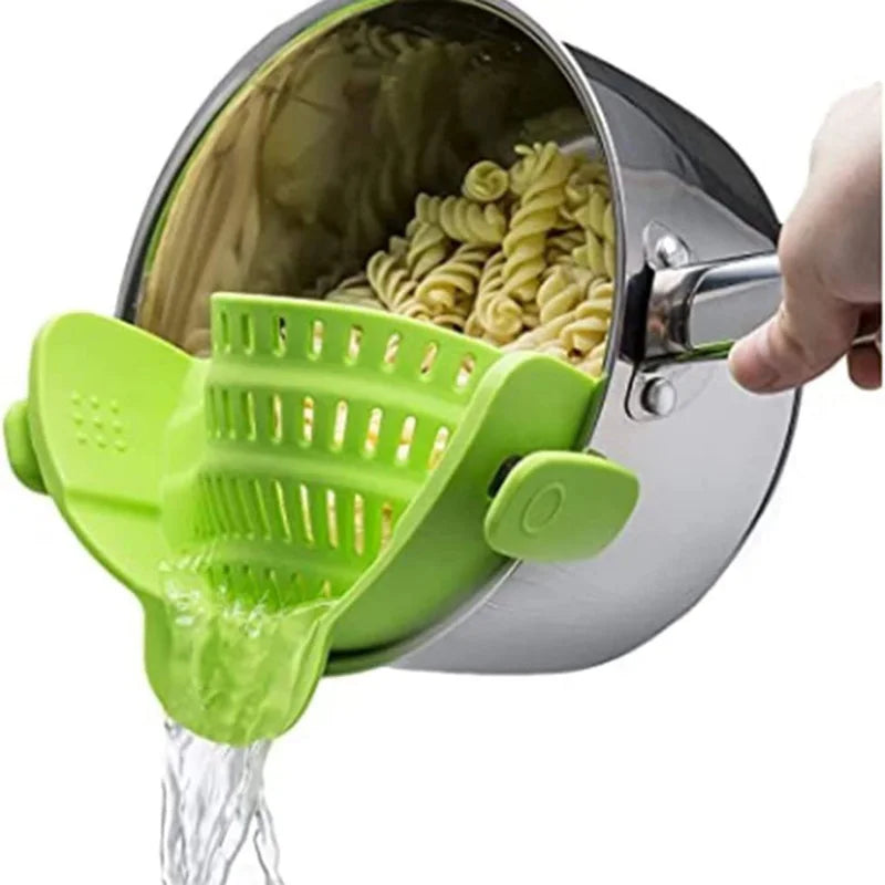 Green pasta scoop being used to serve pasta from a pot