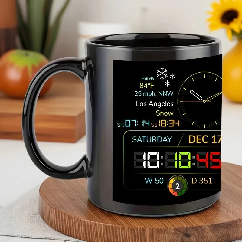 Black mug with digital display showing weather and time information on a wooden surface.