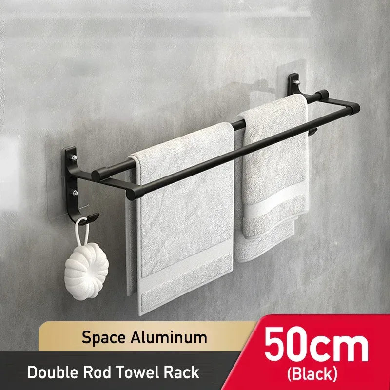 Black double rod towel rack with towels on a gray wall