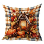 A square decorative throw pillow featuring a rustic autumn harvest design with pumpkins, pinecones, acorns, fall leaves, berries, and a lantern motif, layered over a blue, tan, and cream buffalo plaid background. The pillow is shown against a plain white background.