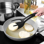 Person frying pancakes in a pan with a spatula on a stove.