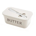 Beige butter dish with a lid on a white background
